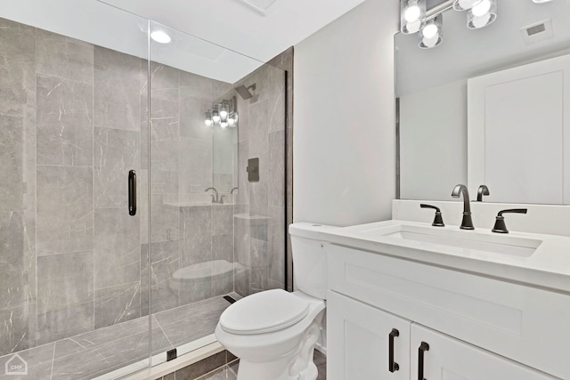 bathroom featuring a stall shower, visible vents, vanity, and toilet