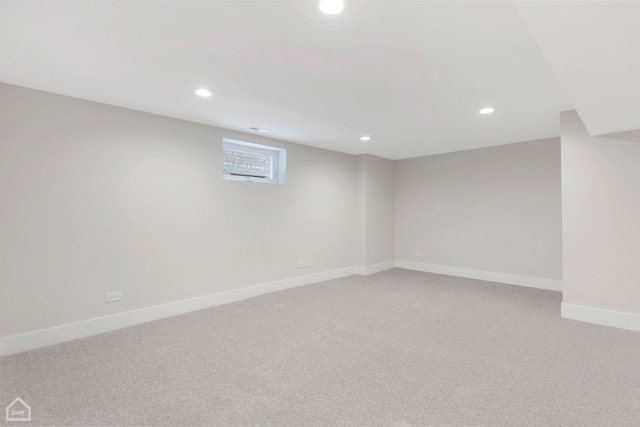 basement featuring visible vents, recessed lighting, light colored carpet, and baseboards