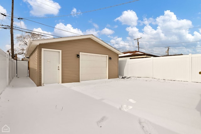 detached garage featuring fence