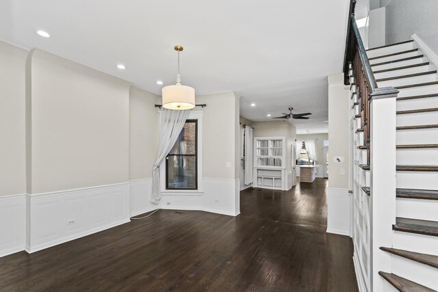 interior space featuring dark wood-style floors, a wainscoted wall, recessed lighting, stairway, and ceiling fan