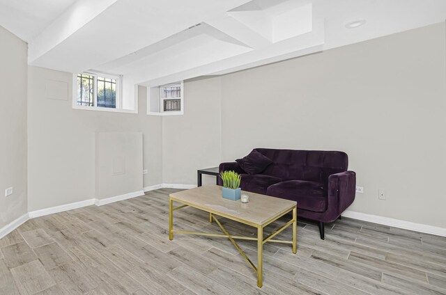 living area with light wood-style floors and baseboards