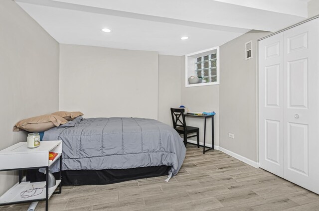 bedroom with light wood-style floors, visible vents, baseboards, and recessed lighting