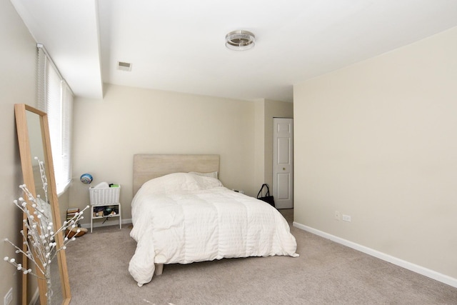 carpeted bedroom featuring visible vents and baseboards