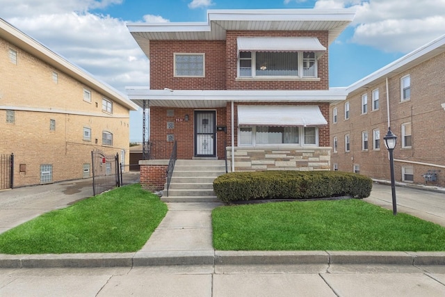 view of front of home with stone siding, brick siding, and a front lawn