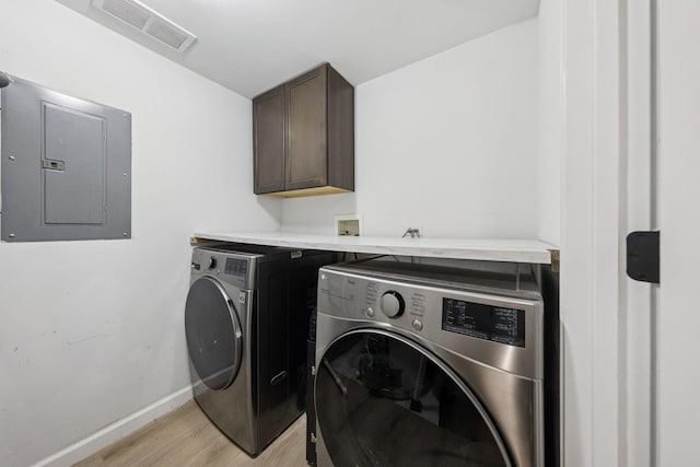 943 Elderberry Cir Unit 303, Naperville, IL 60563 - laundry room featuring electric panel, cabinet space, separate washer and dryer, light wood finished floors, and baseboards