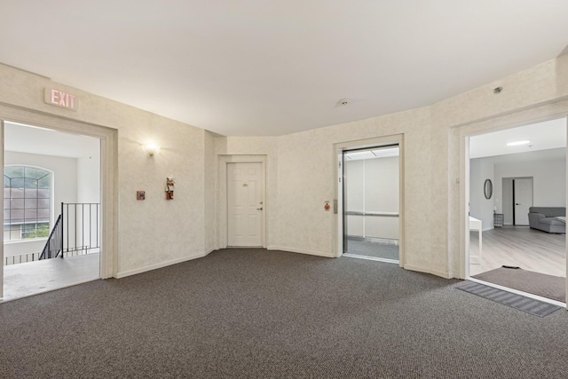 943 Elderberry Cir Unit 303, Naperville, IL 60563 - empty room featuring dark colored carpet and baseboards
