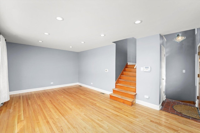 interior space featuring stairs, recessed lighting, light wood-style flooring, and baseboards