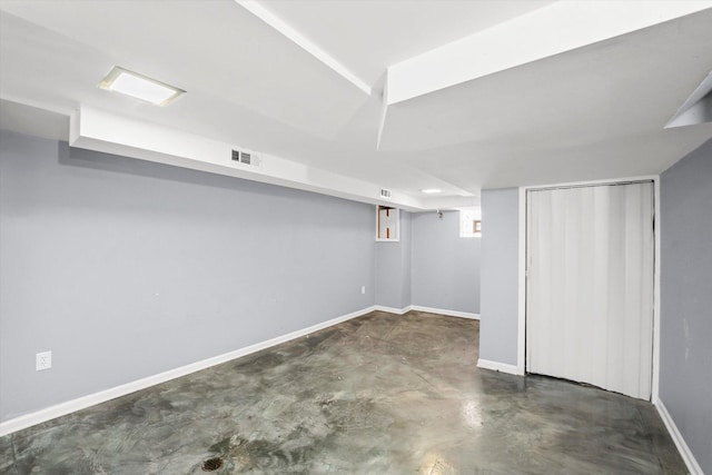 basement featuring visible vents and baseboards