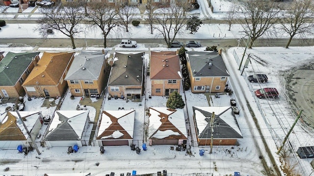 snowy aerial view with a residential view