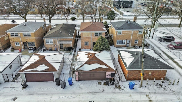 snowy aerial view with a residential view