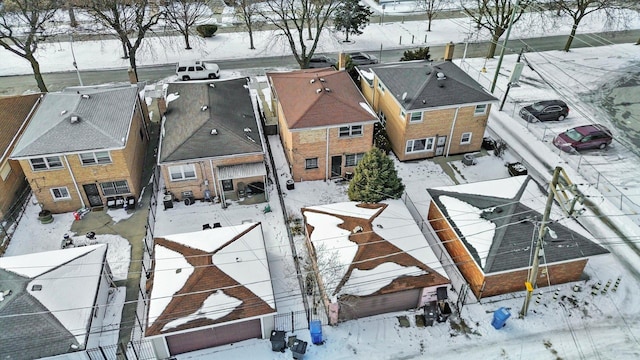 snowy aerial view featuring a residential view