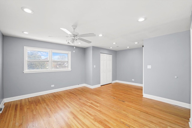 unfurnished room with light wood-style floors, baseboards, and recessed lighting