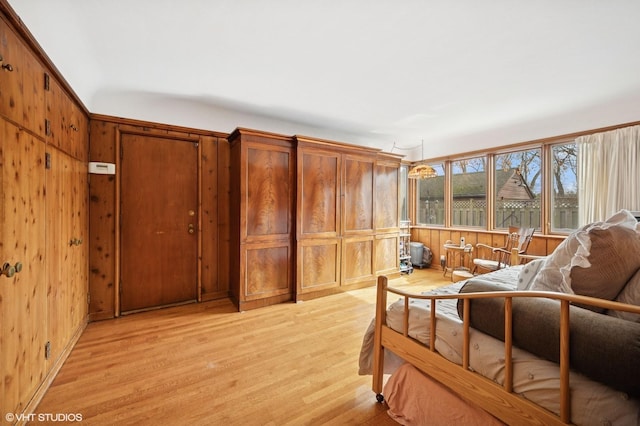 interior space featuring light wood-type flooring and wood walls