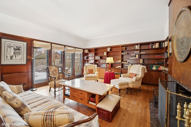 living area with a premium fireplace and wood finished floors