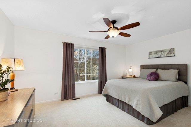 bedroom featuring baseboards, ceiling fan, visible vents, and light colored carpet