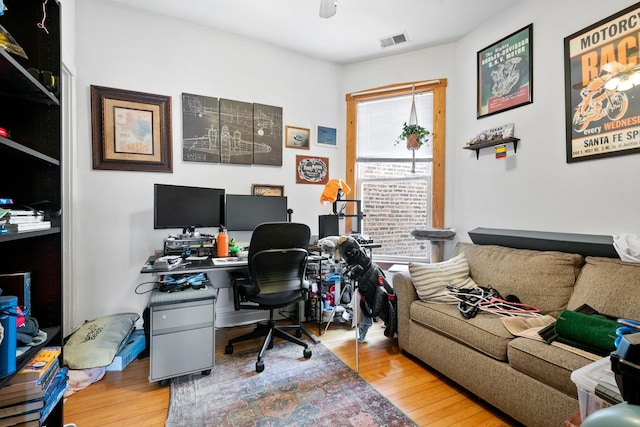 office space featuring light wood-type flooring and visible vents