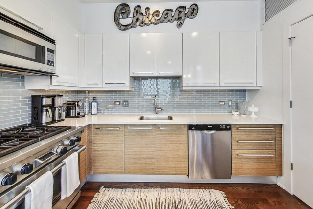 kitchen with white cabinetry, stainless steel appliances, and light countertops