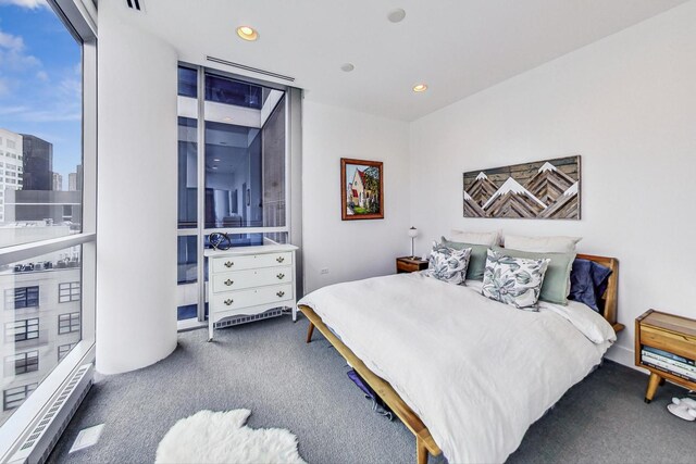 bedroom with carpet floors, a city view, and recessed lighting