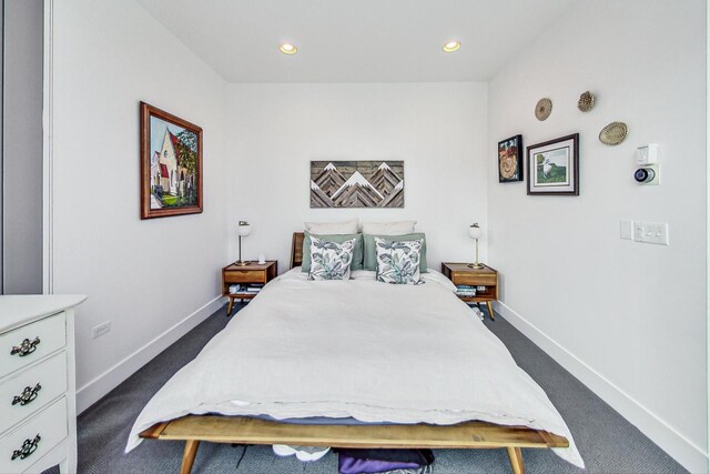 bedroom featuring recessed lighting, dark carpet, and baseboards