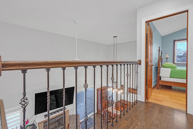 hall with vaulted ceiling and wood finished floors