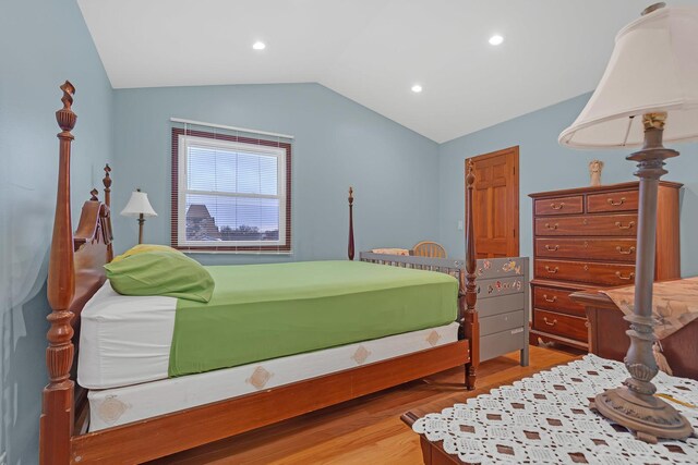 bedroom with vaulted ceiling, wood finished floors, and recessed lighting