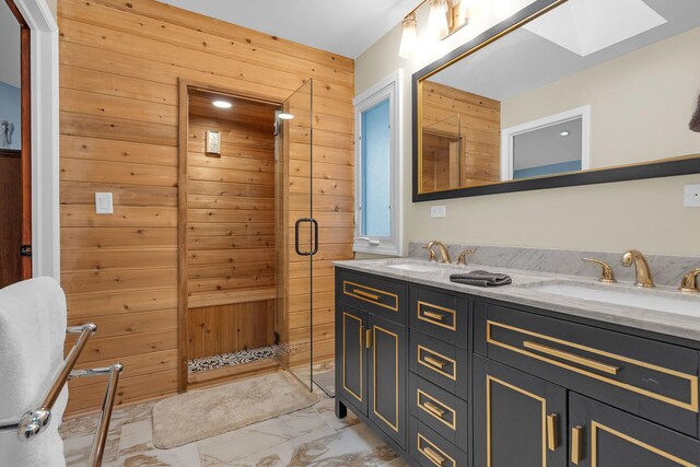 full bathroom with marble finish floor, double vanity, wood walls, and a sink