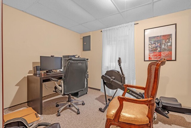 carpeted office featuring a paneled ceiling, electric panel, and baseboards