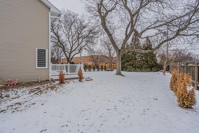 yard covered in snow with fence