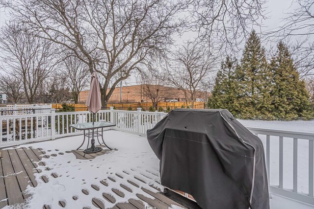 snow covered deck featuring area for grilling