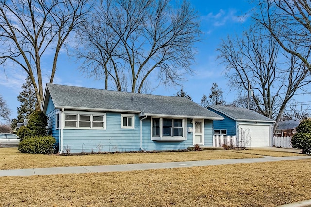 single story home featuring a garage, a shingled roof, a front yard, and fence