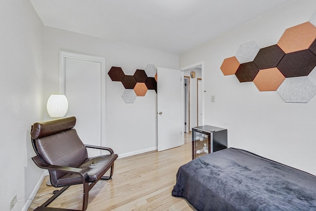 bedroom with light wood-style flooring and baseboards