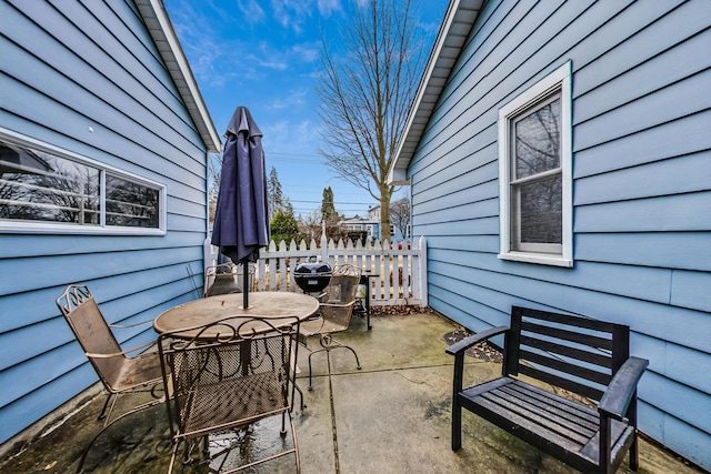 view of patio with outdoor dining space and fence