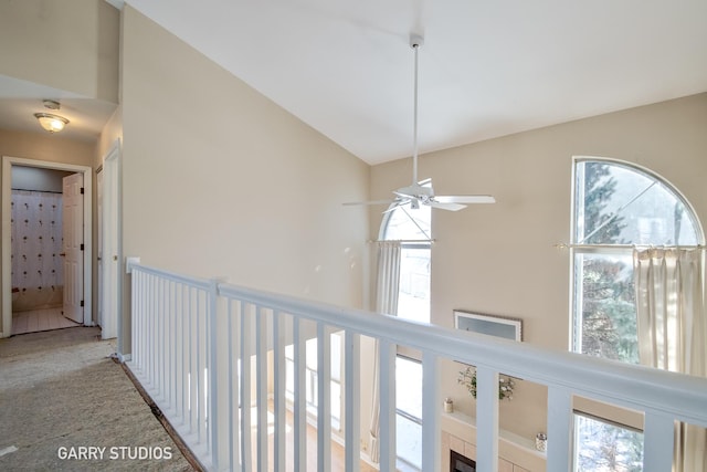 hall featuring vaulted ceiling and light colored carpet