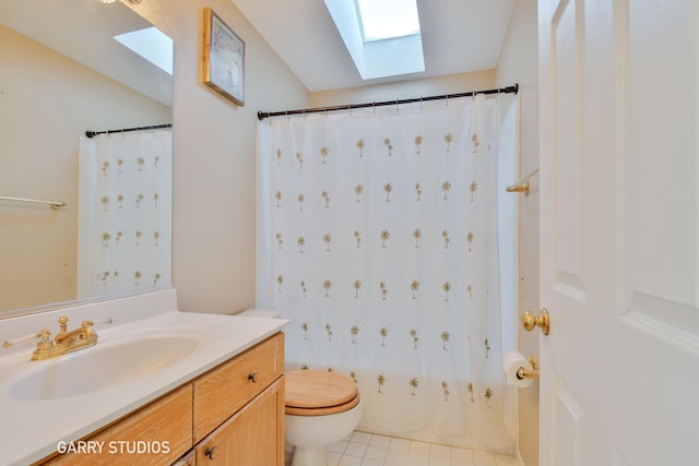 bathroom featuring a skylight, vanity, and toilet