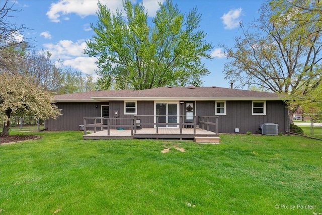 back of house with a lawn, central AC, a deck, and fence