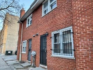 view of property exterior featuring brick siding and a chimney