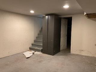 finished basement featuring stairway and recessed lighting