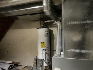 utility room featuring gas water heater