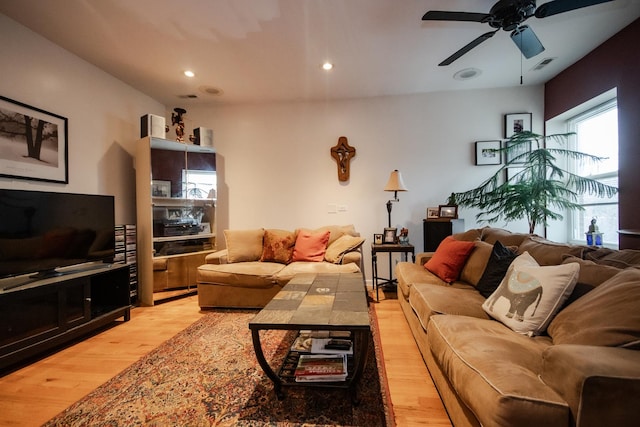 living room featuring light wood-type flooring, visible vents, a ceiling fan, and recessed lighting