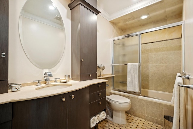 bathroom featuring toilet, tiled shower / bath combo, visible vents, vanity, and crown molding