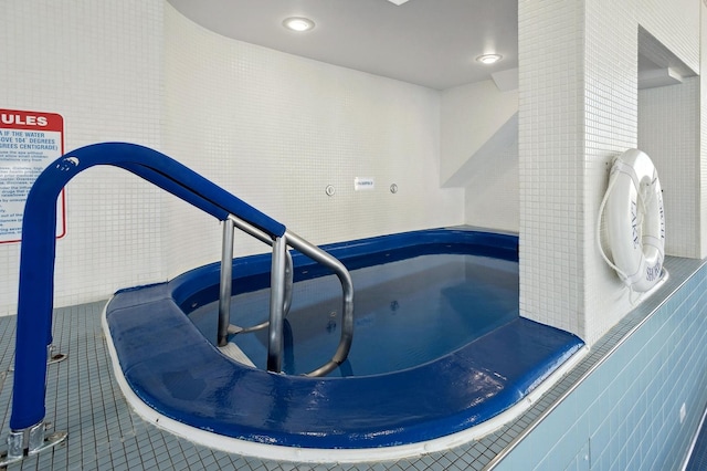 view of pool featuring an indoor hot tub