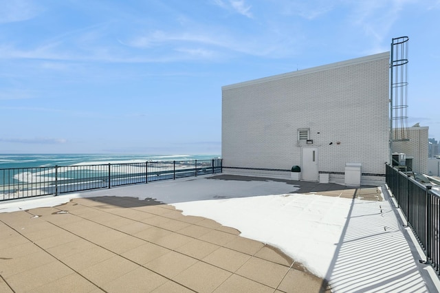 view of patio with a water view