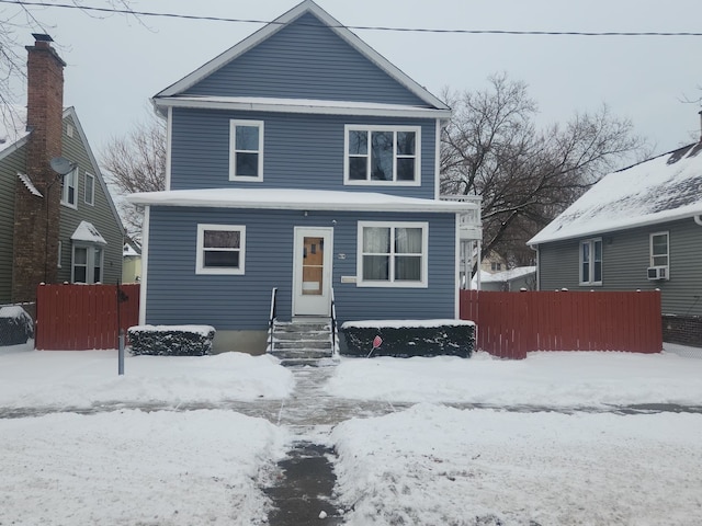 traditional style home featuring fence and cooling unit