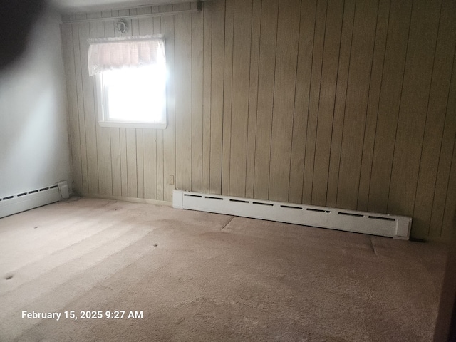 empty room featuring carpet floors and baseboard heating