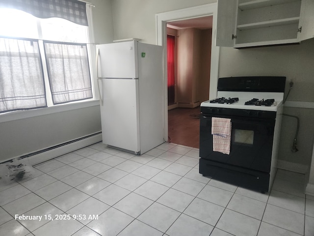 kitchen with freestanding refrigerator, light tile patterned flooring, a baseboard radiator, and gas range