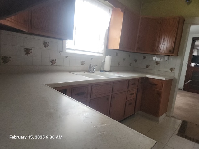 kitchen with brown cabinets, light countertops, and a sink