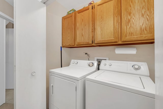 washroom with cabinet space and washing machine and clothes dryer