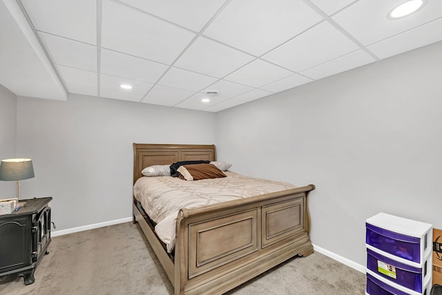 bedroom featuring light carpet, recessed lighting, a paneled ceiling, and baseboards