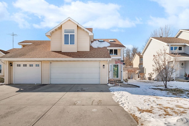 traditional-style house with a garage, concrete driveway, and roof with shingles