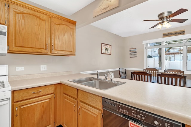 kitchen featuring a peninsula, white appliances, a sink, a ceiling fan, and light countertops